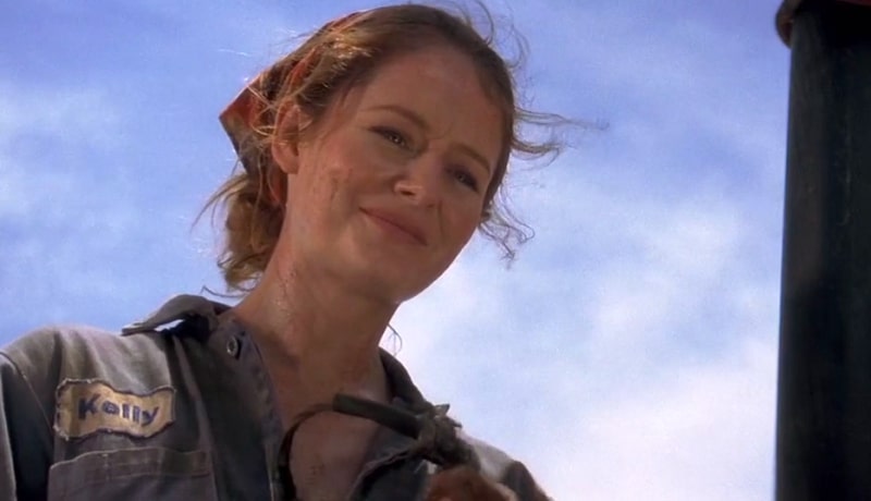 Miranda Otto looking down with a red bandana and oil rig workers clothes.