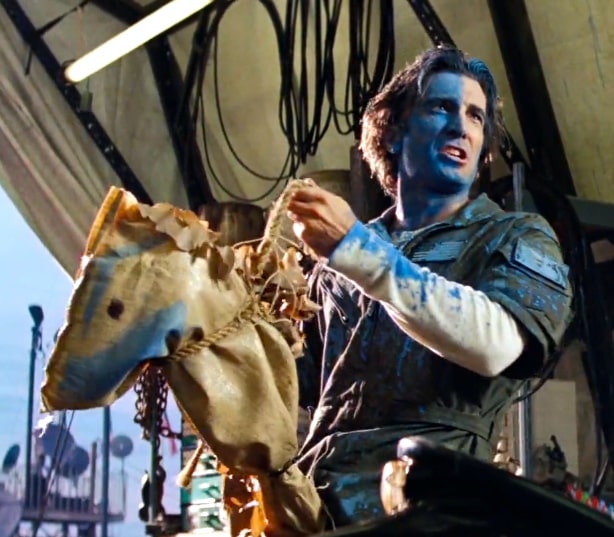 Sharlto Copley as Murdock doing his best Braveheart cosplay with blue paint and wooden horse.