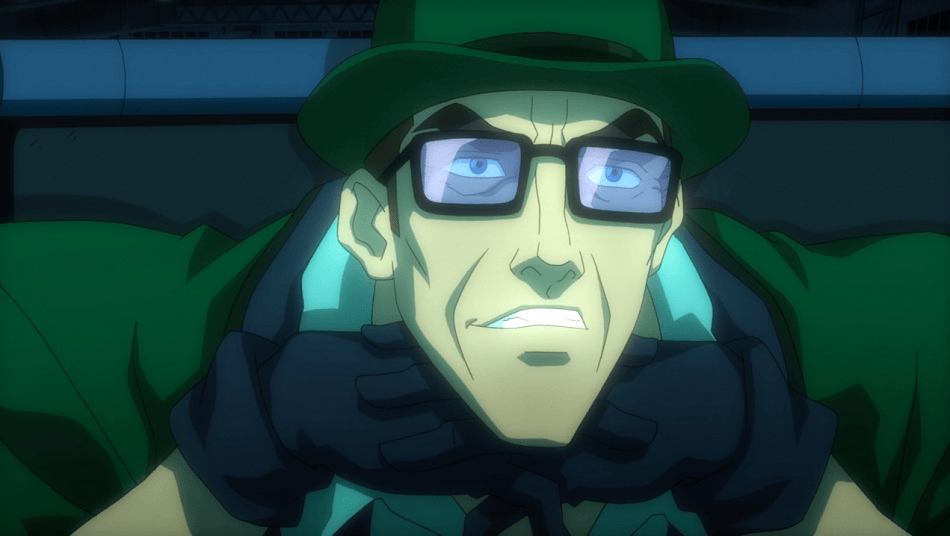 The Riddler in green clothes and glasses leaning on his hands and smiling.
