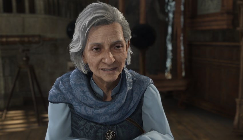 Dinah Hecat with grey hair and warm expression inside an old brown room.