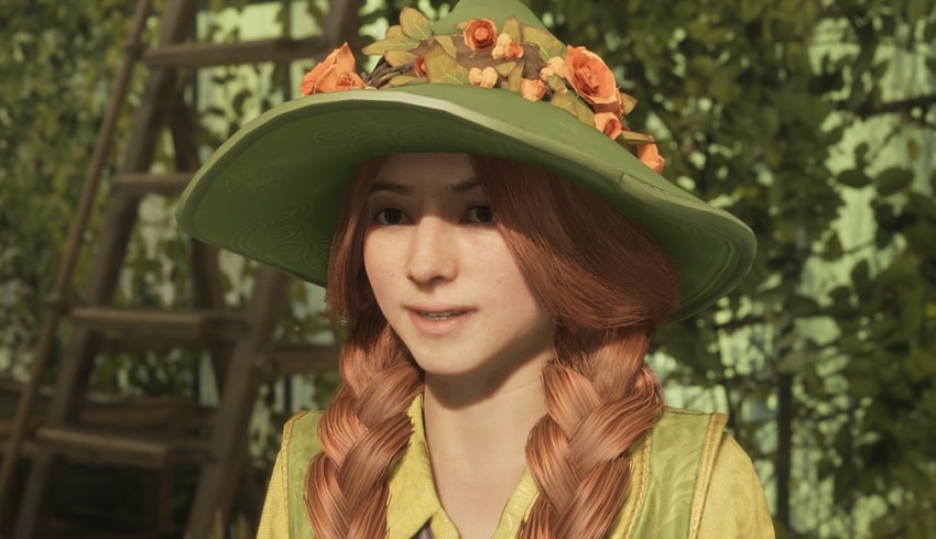 Mirabel Garlick with braided hair and green hat with flowers on it in a botanical house.