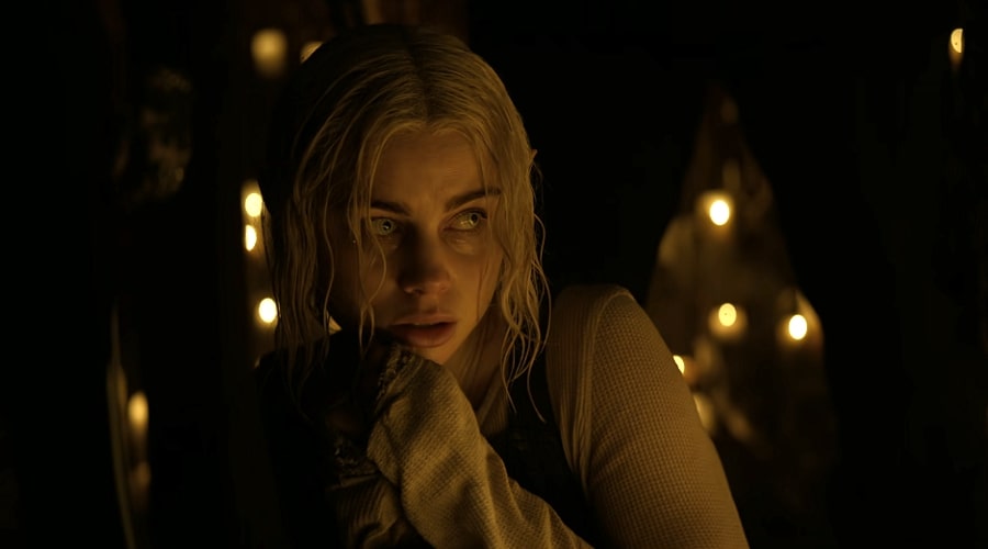 Lucy Fry as Tikka looking shy and scared in a dimly lit room in Bright.